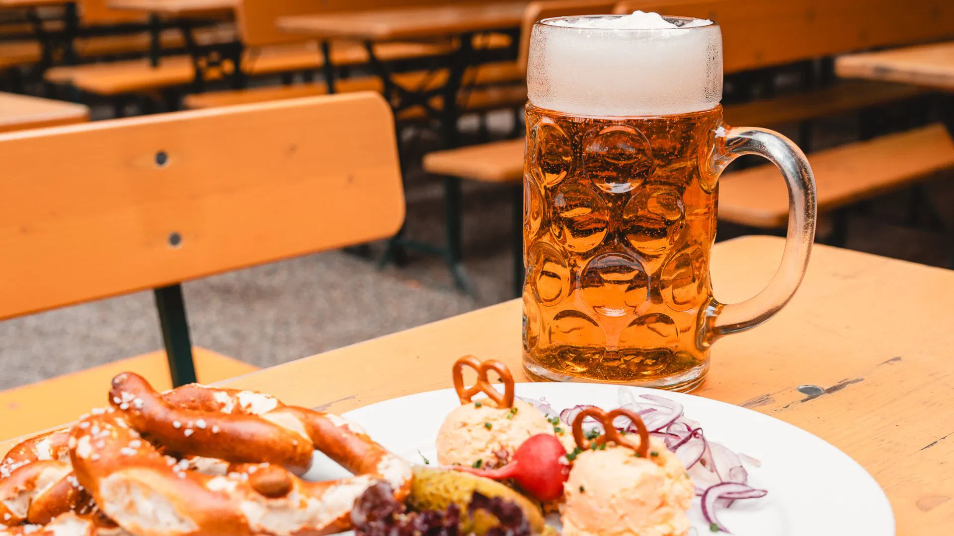A Bavarian brotzeit board with bread, cold cuts and a glass of beer.